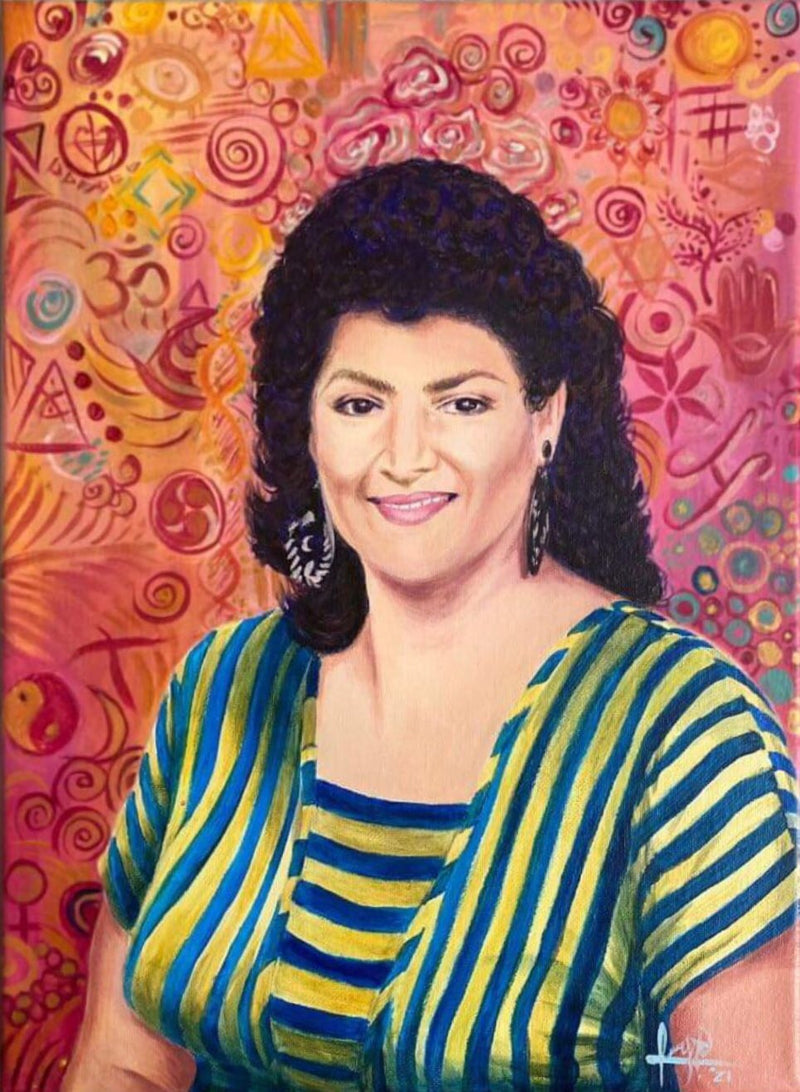 Woman in a striped shirt against a colorful abstract background